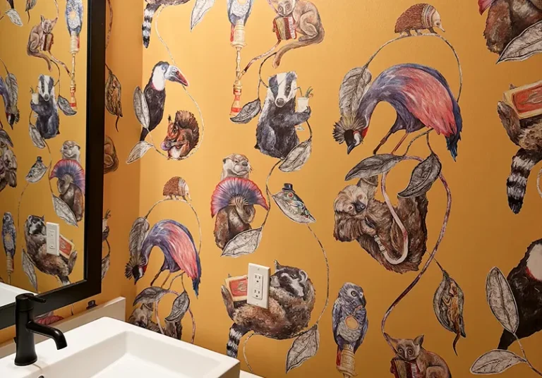 Professional wallpaper installation with bold animal-print pattern in a Colorado powder room