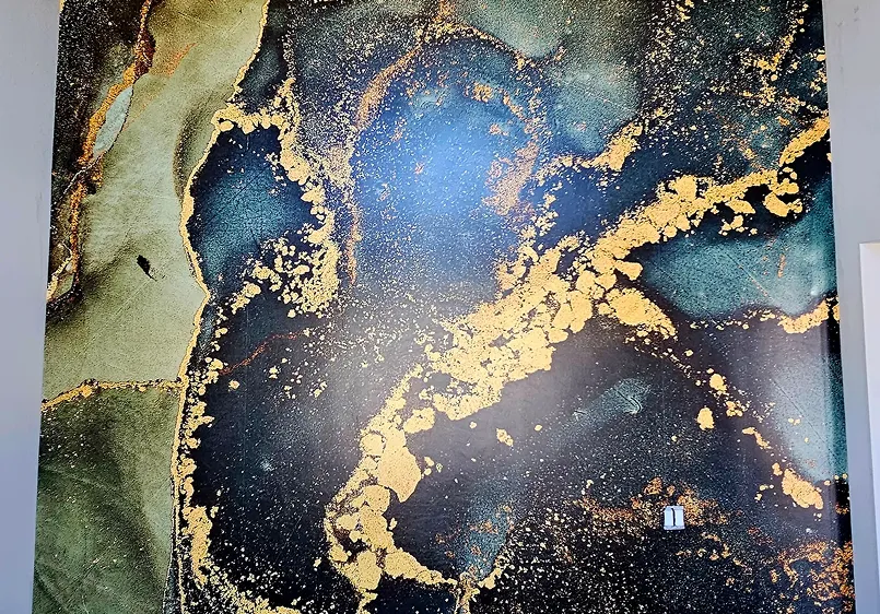 Professional wallpaper installation with blue and gold marbled pattern in a Colorado home